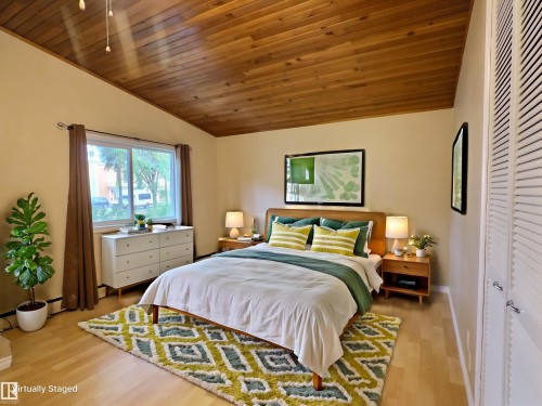 Sloped wood-paneled ceiling with recessed lighting, light wood-finish flooring, and a wide window with a lower transom - 79 Grosvenor Boulevard, St. Albert, AB 