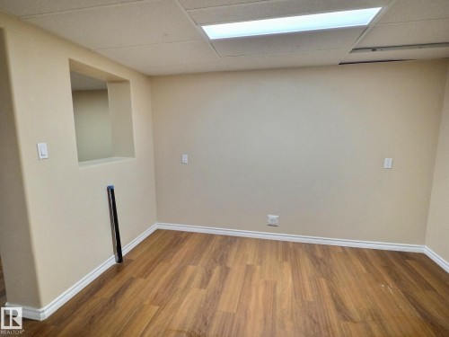 Neutral tone painted walls with wood-finish flooring - 79 Grosvenor Boulevard, St. Albert, AB 