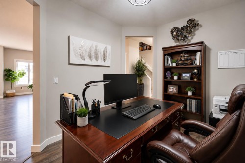 Dedicated office space featuring wood-finish flooring, light neutral wall paint, and recessed lighting - 101 Hilldowns Drive, Spruce Grove, AB 