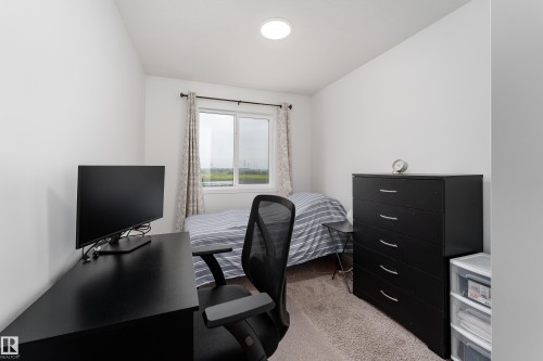 Bright room featuring neutral wall paint, a single window with drapes, and a ceiling-mounted light fixture - 2522 152 Avenue Nw, Edmonton, AB - Indoor Photo Showing Office