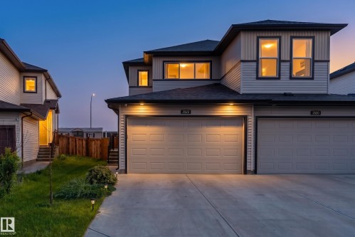 Modern townhome exterior featuring light-toned siding and dark trim - 2522 152 Avenue Nw, Edmonton, AB - Outdoor