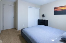 Neutral wall paint, carpeted flooring, and a sliding-door closet - 