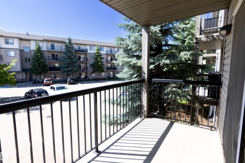 Private balcony featuring a concrete surface and black metal railings - #214 1188 Hyndman Rd Nw, Edmonton, AB - Outdoor