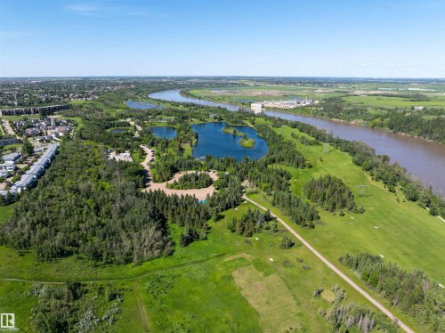 Expansive aerial perspective showcasing a river, multiple bodies of water, and extensive green spaces - #214 1188 Hyndman Rd Nw, Edmonton, AB - Outdoor With View