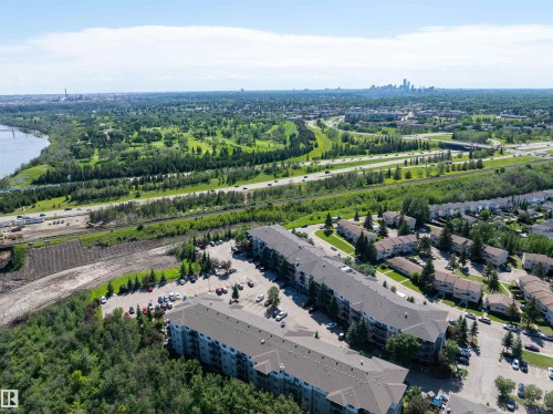 Aerial perspective showcasing two multi-story apartment buildings with ample surface parking - #214 1188 Hyndman Rd Nw, Edmonton, AB - Outdoor With View