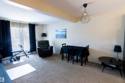 Carpeted living space featuring a sliding glass door with balcony access - 