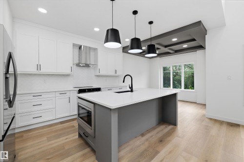 Contemporary kitchen featuring a large central island with an integrated microwave - 915 Elderberry Landing Nw, Edmonton, AB - Indoor Photo Showing Kitchen With Upgraded Kitchen