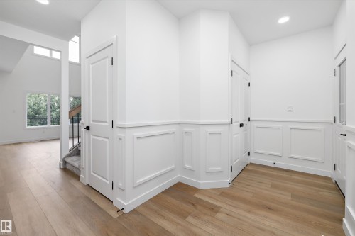 Entryway featuring light wood-finish flooring and wainscoting - 915 Elderberry Landing Nw, Edmonton, AB - Indoor Photo Showing Other Room