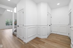 Entryway featuring light wood-finish flooring and wainscoting - 
