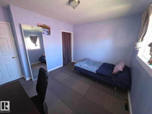Light blue painted walls complement the textured flooring - 10404 116 Avenue, Edmonton, AB 