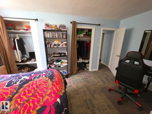 Room featuring light blue walls and gray-toned carpet-tile flooring - 10404 116 Avenue, Edmonton, AB 