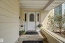 Front entryway featuring a white arch-top door with sidelight windows, light-colored brick facade, and horizontal siding - 170 Westridge Rd, Edmonton, AB  - Outdoor With Exterior 