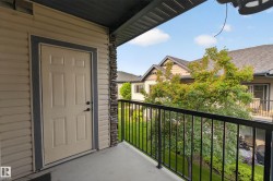 Private balcony featuring a black metal railing and concrete flooring - 