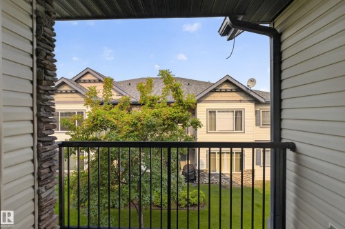Private balcony featuring black metal railings and a stacked stone pillar accent - 18 2565 Hanna Crescent, Edmonton, AB 
