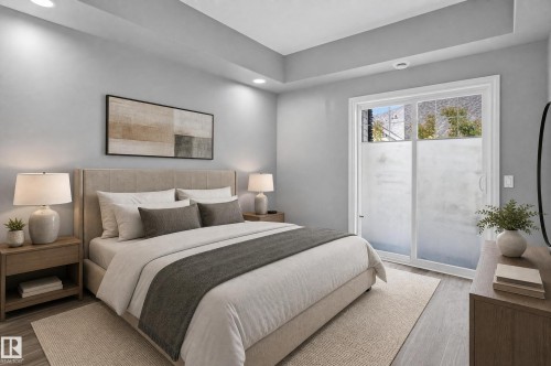 Bedroom featuring a tray ceiling with recessed lighting, wood-finish flooring, and a sliding glass door - 18 2565 Hanna Crescent, Edmonton, AB 