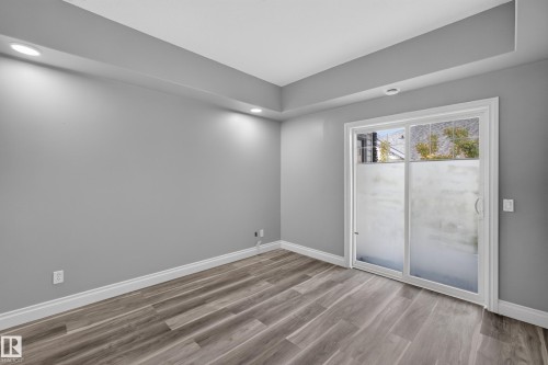 Room featuring wood-finish flooring, recessed lighting, and a tray ceiling - 18 2565 Hanna Crescent, Edmonton, AB 
