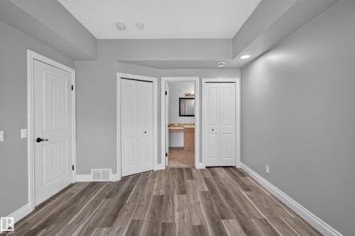 Wood-finish flooring throughout, complemented by white baseboards and trim - 18 2565 Hanna Crescent, Edmonton, AB 