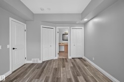 Wood-finish flooring throughout, complemented by white baseboards and trim - 