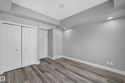 Room featuring wood-finish flooring, recessed lighting, bi-fold closet doors, and light gray wall paint with white trim - 