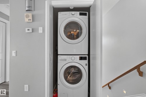 Dedicated laundry closet featuring a stacked washer and dryer unit - 18 2565 Hanna Crescent, Edmonton, AB 