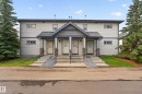 Cream-colored siding building featuring a dark gray roof - 18 2565 Hanna Crescent, Edmonton, AB 