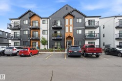 Contemporary multi-story building featuring dark gray and white siding with natural wood-tone accents - 