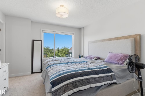 Bright room featuring a large window, neutral carpeting, and white walls - 170 804 Welsh Drive, Edmonton, AB 