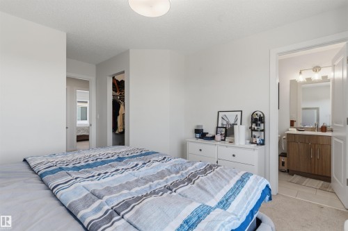 Bedroom with light neutral carpet and white walls - 170 804 Welsh Drive, Edmonton, AB 