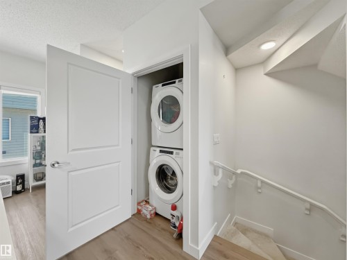 Dedicated laundry closet featuring a stacked washer and dryer - 170 804 Welsh Drive, Edmonton, AB 