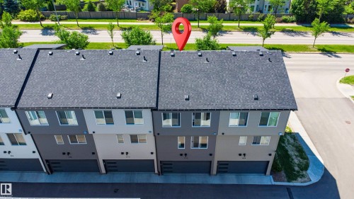Contemporary townhome exterior featuring a dark grey shingle roof and a multi-tone facade - 170 804 Welsh Drive, Edmonton, AB 