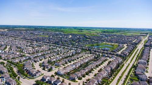 Expansive residential development featuring numerous single-family homes with varied architectural styles, a central retention pond, and broad roadways - 170 804 Welsh Drive, Edmonton, AB 