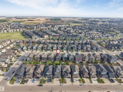 Aerial perspective showcasing a developed residential neighborhood with a variety of single-family homes and townhomes - 