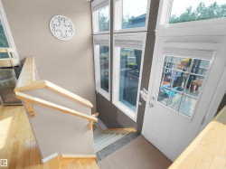 Interior staircase featuring natural wood-finish flooring, a light-toned wood handrail, and a white decorative wall accent - 