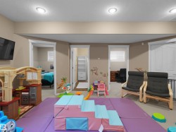Open room featuring recessed lighting, neutral wall tones, and carpet flooring, with multiple doorways leading to additional interior spaces - 