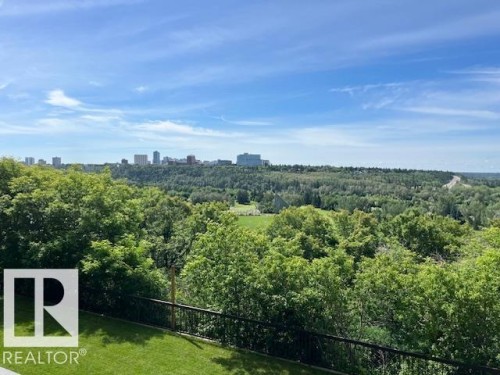 Expansive landscape featuring distant city skyline, mature trees, and a manicured lawn area - 1101 10011 123 Street, Edmonton, AB 