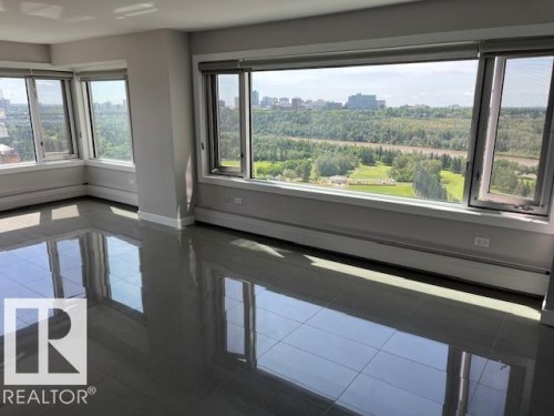 Spacious room featuring expansive windows with roller blinds, offering panoramic scenery - 1101 10011 123 Street, Edmonton, AB 