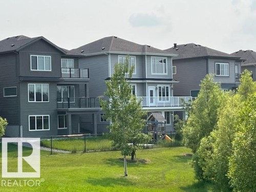 Contemporary multi-level residence featuring a gray exterior with contrasting dark gray accents - 3810 46 Avenue, Beaumont, AB 