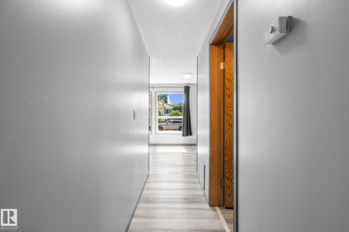 Hallway featuring light wood-finish flooring, recessed lighting, and a neutral wall palette - 31 Graywood Cove, Stony Plain, AB 
