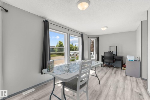 Room featuring light gray walls and wood-finish flooring - 31 Graywood Cove, Stony Plain, AB 