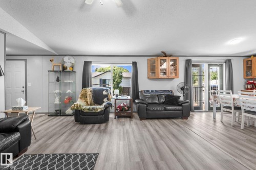Open concept living space featuring wood-finish flooring throughout - 31 Graywood Cove, Stony Plain, AB 