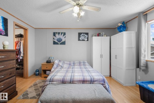 Room with light wood-finish flooring and a ceiling fan with integrated lighting - 31 Graywood Cove, Stony Plain, AB 