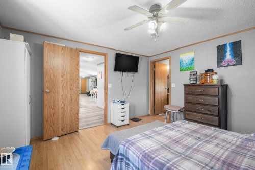 Interior room featuring wood-finish flooring and light gray painted walls - 31 Graywood Cove, Stony Plain, AB 