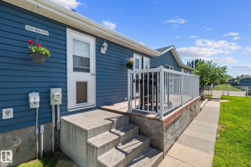 Exterior featuring blue horizontal siding and a white trim - 31 Graywood Cove, Stony Plain, AB 
