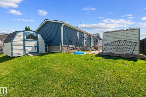Generous green space accompanies this property, featuring a blue-sided residence - 31 Graywood Cove, Stony Plain, AB 