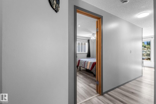 Hallway featuring light gray walls and wood-finish flooring - 31 Graywood Cove, Stony Plain, AB 