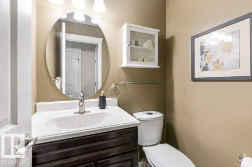 Bathroom vanity with a white countertop and integrated sink - 1119 Potter Greens, Edmonton, AB - Indoor Photo Showing Bathroom