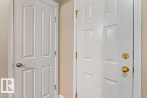 White paneled doors featuring brushed nickel hardware and polished brass hardware - 1119 Potter Greens, Edmonton, AB -  Photo Showing Other Room