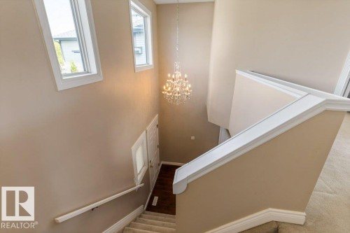 Two-story entryway featuring a crystal chandelier - 1119 Potter Greens, Edmonton, AB - Indoor Photo Showing Other Room