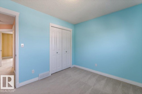Room featuring light blue walls and plush gray carpeting - 1119 Potter Greens, Edmonton, AB - Indoor Photo Showing Other Room