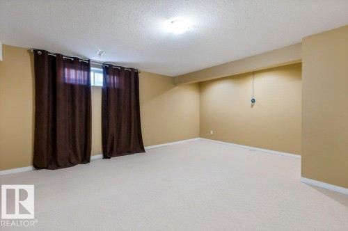 Spacious room with light-toned carpet flooring and neutral wall paint - 1119 Potter Greens, Edmonton, AB - Indoor Photo Showing Other Room